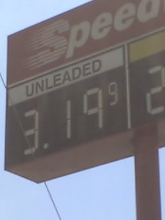 Sign at a gas station showing a gallon of gasoline costing $3.19